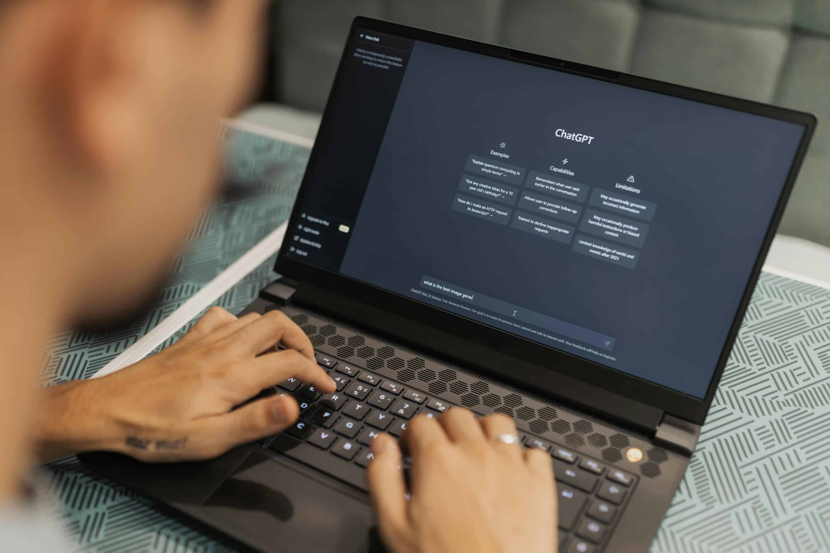 Person using a laptop with AI interface representing Cotes Code building structured digital entities and brand authority for answer engine optimization