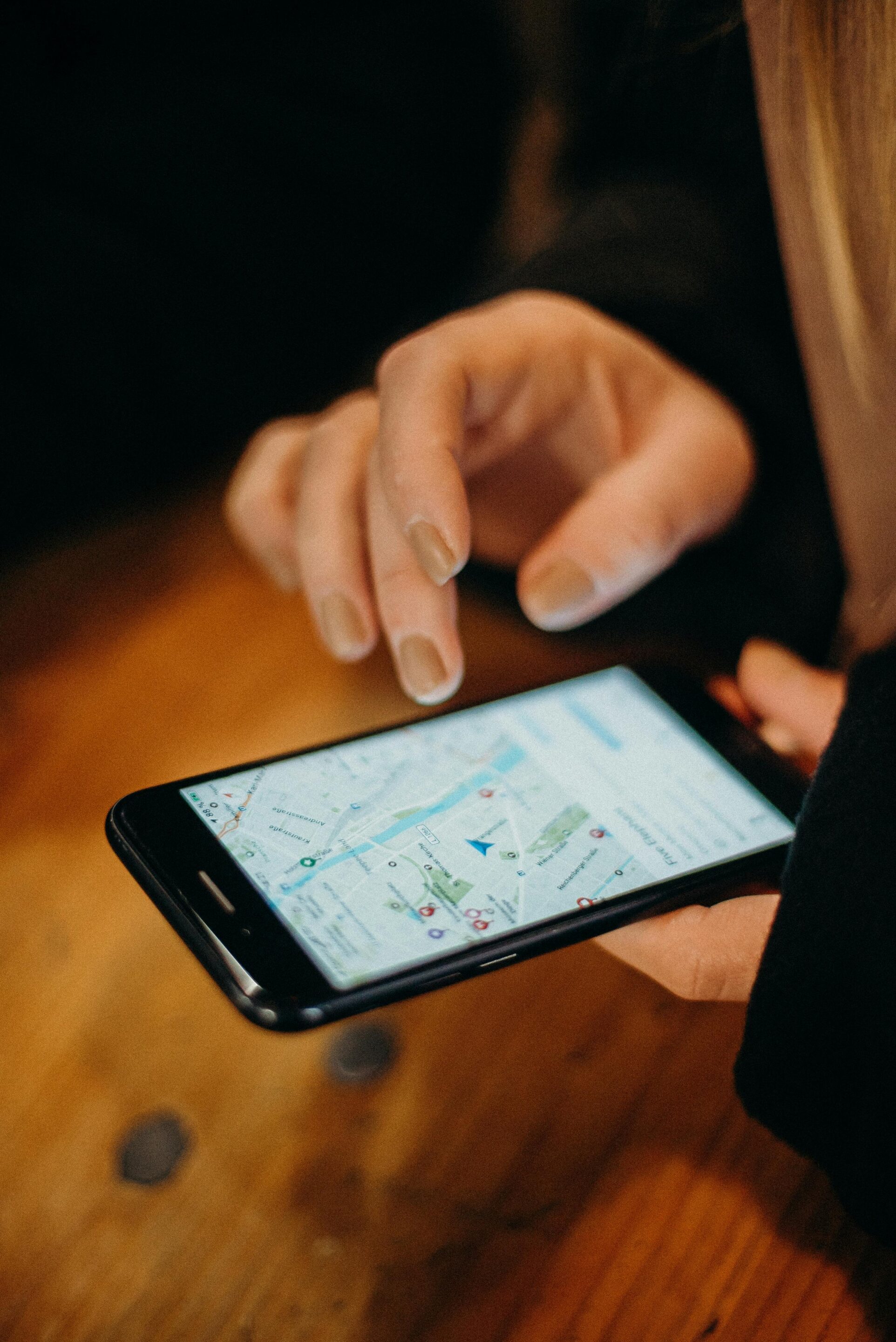 Person using a smartphone map interface to analyze local search visibility and geo-grid rankings, representing map rank tracking and local SEO performance insights for businesses in Grand Rapids, Detroit, and Marquette.