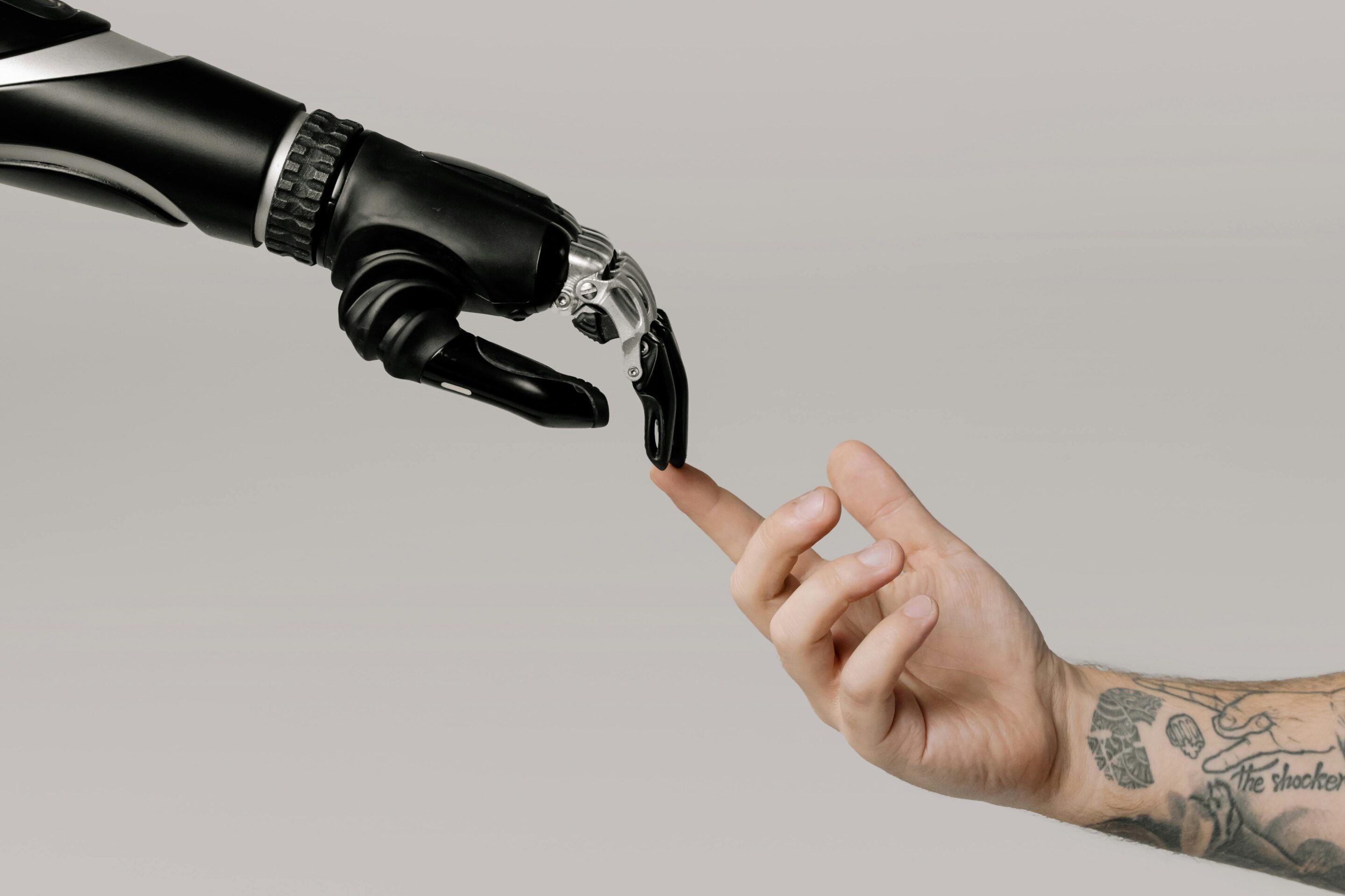 Human hand touching a robotic hand symbolizing trust and digital reputation building by Cotes Code for businesses in Grand Rapids, Ada, and surrounding West Michigan